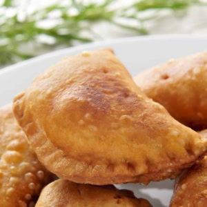 closeup of a plate with some spanish empanadillas, small meat or tuna pies, served as tapas