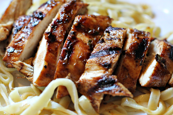 Grilled rosemary chicken on a bed of fresh pasta