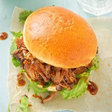 Pulled Pork Sandwich on hawaiian bun set upon a white napkin