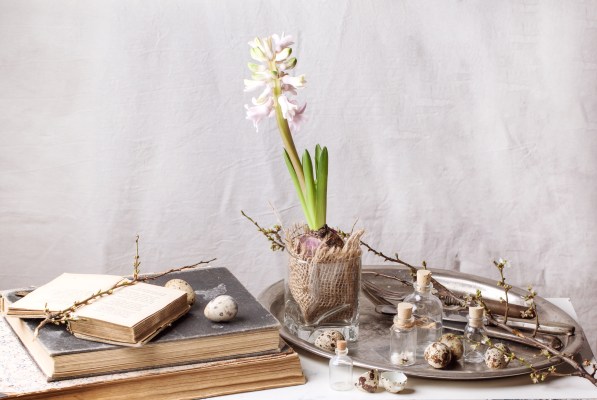 vintage decorate books next to a tray with flowers and knick knacks