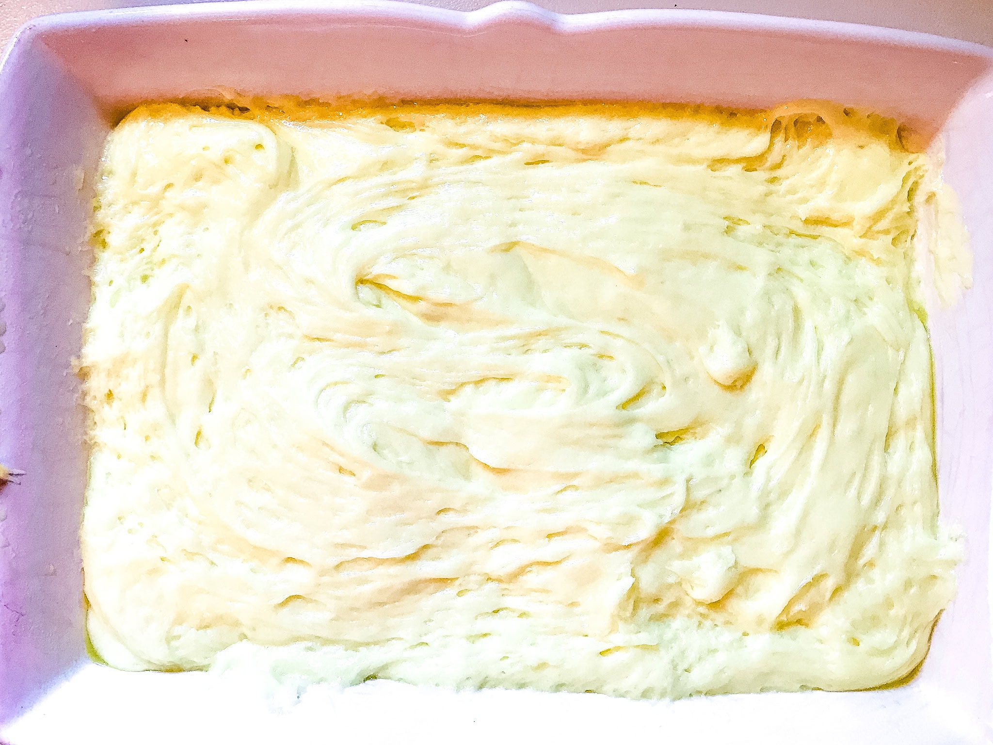 lemon bar batter in a white 9x13 inch pan