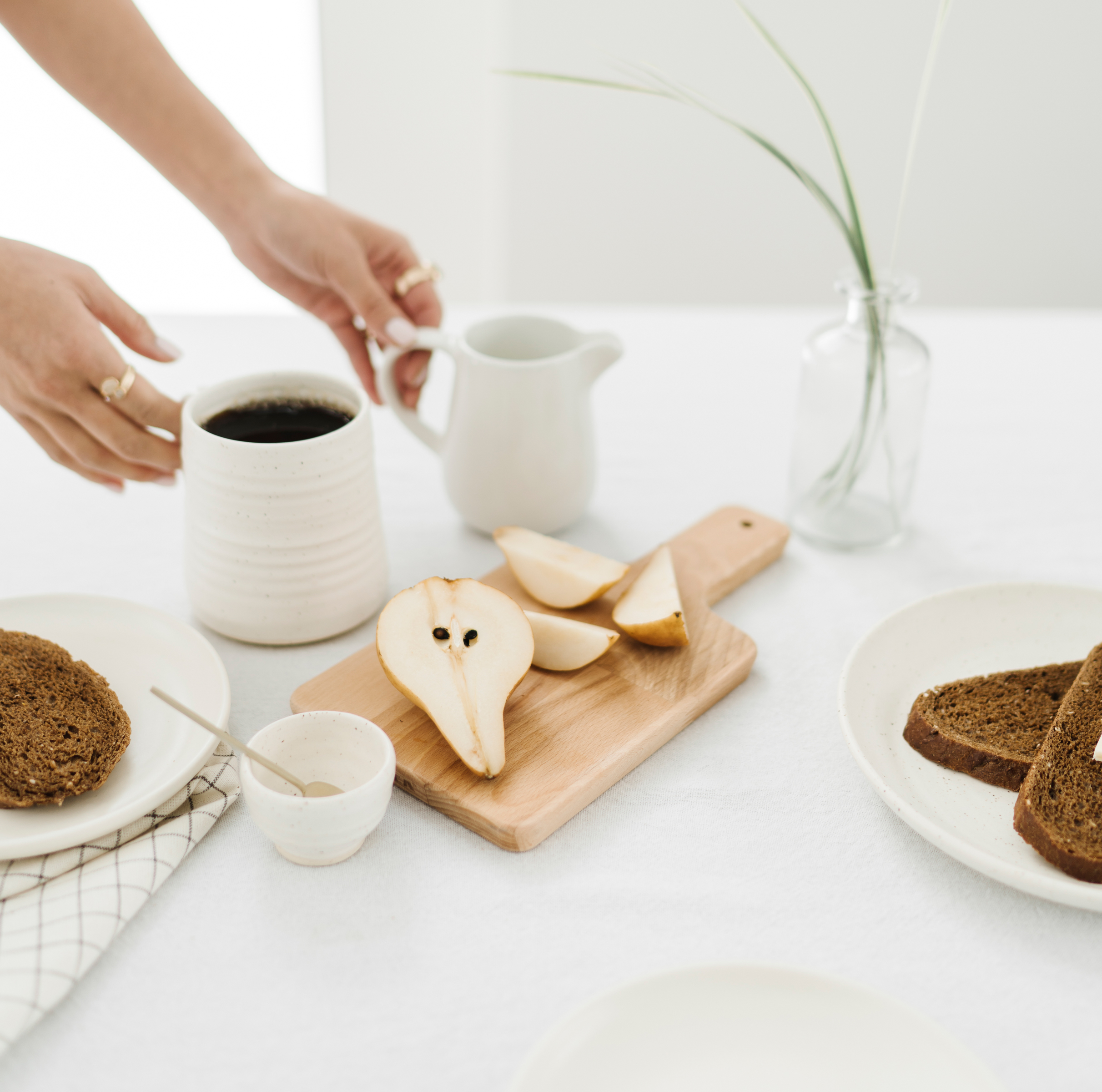 non-descript woman serving coffee and breakfast items