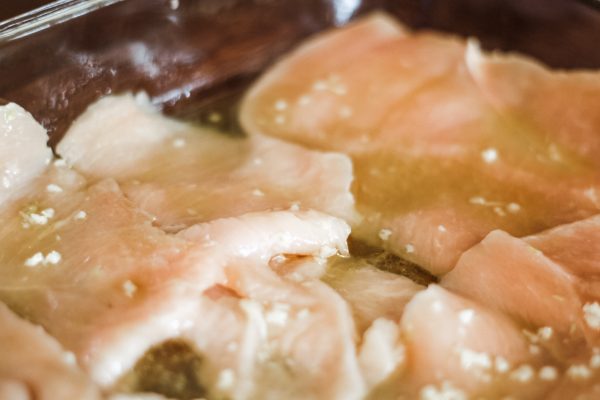 Raw Chicken Breasts marinating in Garlic and Lime