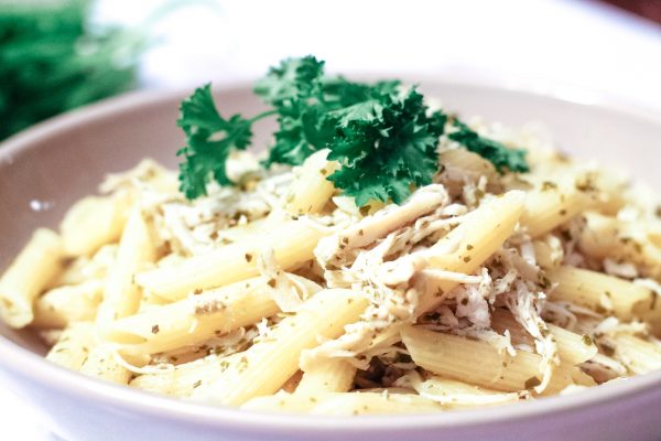 Pesto Chicken Pasta in a gray bowl with parsley