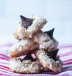 5 coconut kiss macaroons stacked on a red and white striped cloth