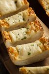 Cheesy Garlic Bread Slices on a cutting board