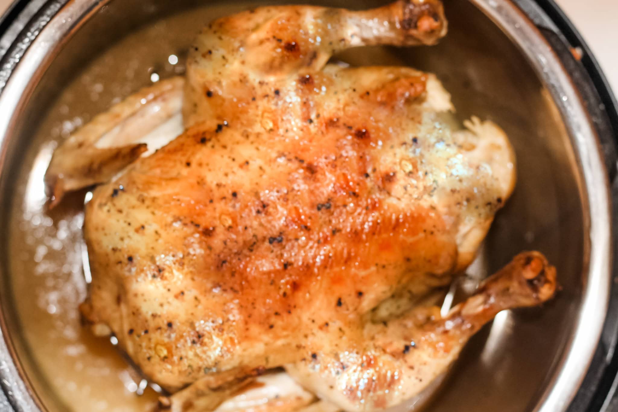 Overhead view of roasted whole chicken in an instant pot