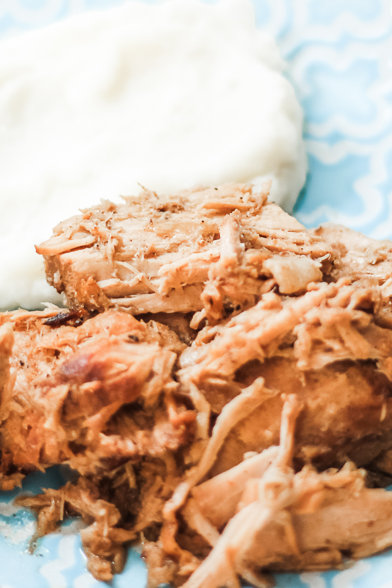 pork and mashed potatoes on a blue plate