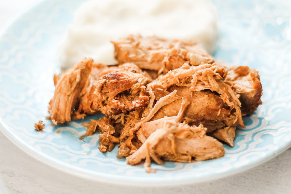 slow cooker balsamic pork and mashed potatoes on a blue plate