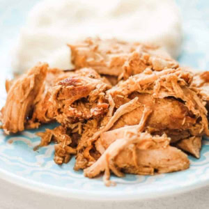 slow cooker balsamic pork and mashed potatoes on a blue plate