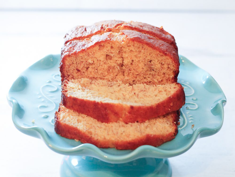 sliced loaf of banana bread on a cakestand