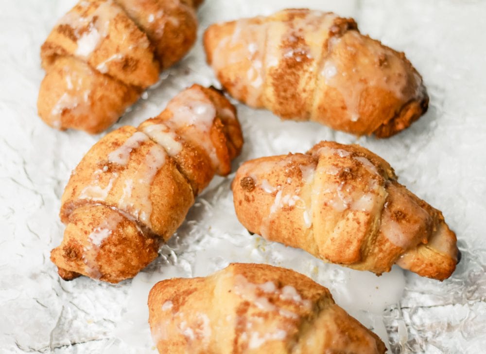 Glazed Cinnamon Roll Crescents on a glass tray