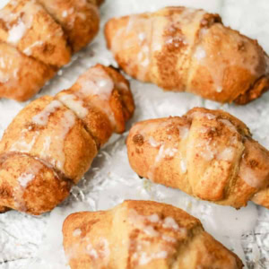 Glazed Cinnamon Roll Crescents on a glass tray