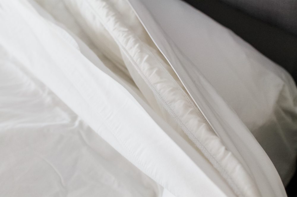 Duvet covered encased by two flat sheets