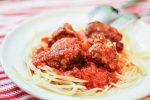 ground beef meatballs and spaghetti on a white plate