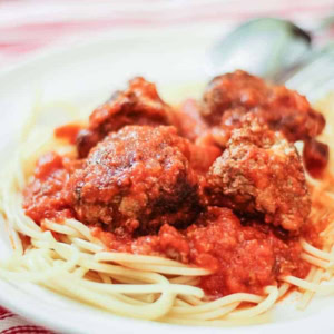ground beef meatballs and spaghetti on a white plate