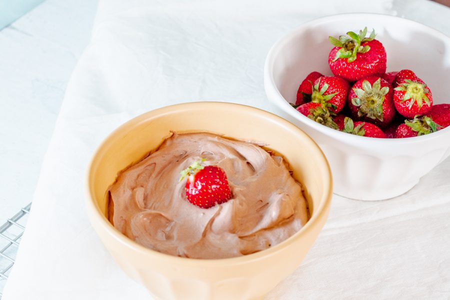 bowl of 3-ingredient chocolate fruit dip next to a bowl of strawberries