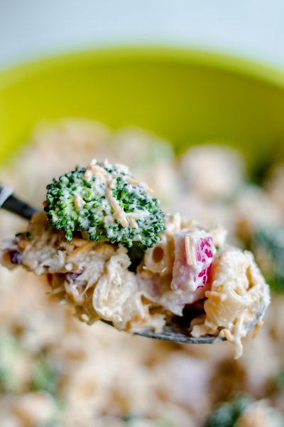 forkful of chicken pasta salad with broccoli and red onion
