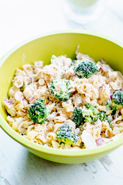 close up of bowl of chicken pasta salad with broccoli