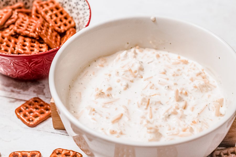 bowls of cold beer cheese dip and square pretzels