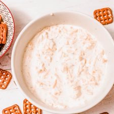 bowls of cold beer cheese dip and square pretzels