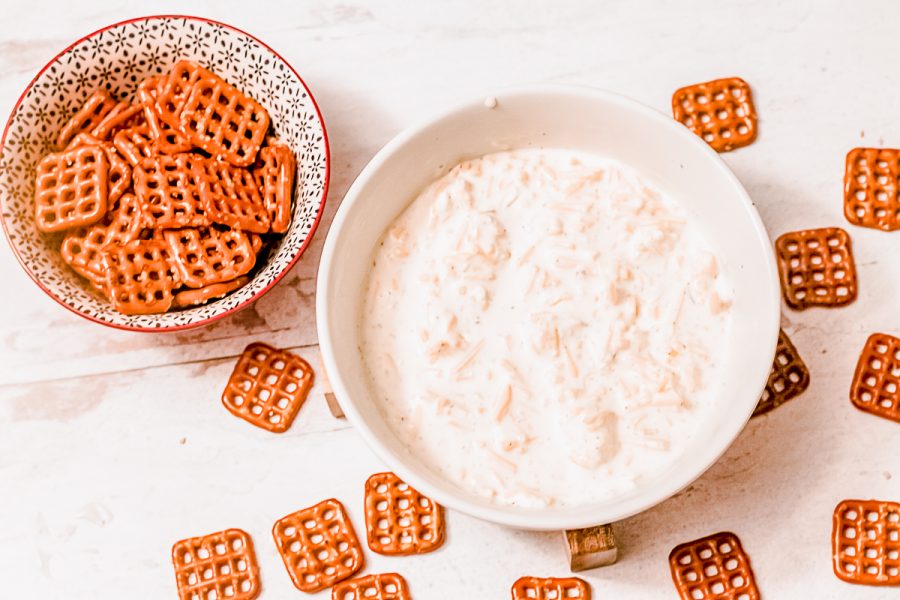 bowls of cold beer cheese dip and square pretzels