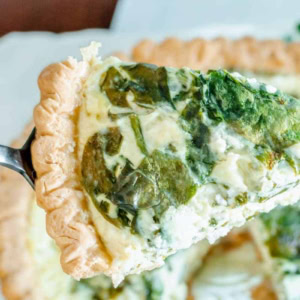 slice of fresh spinach and feta and swiss cheese quiche