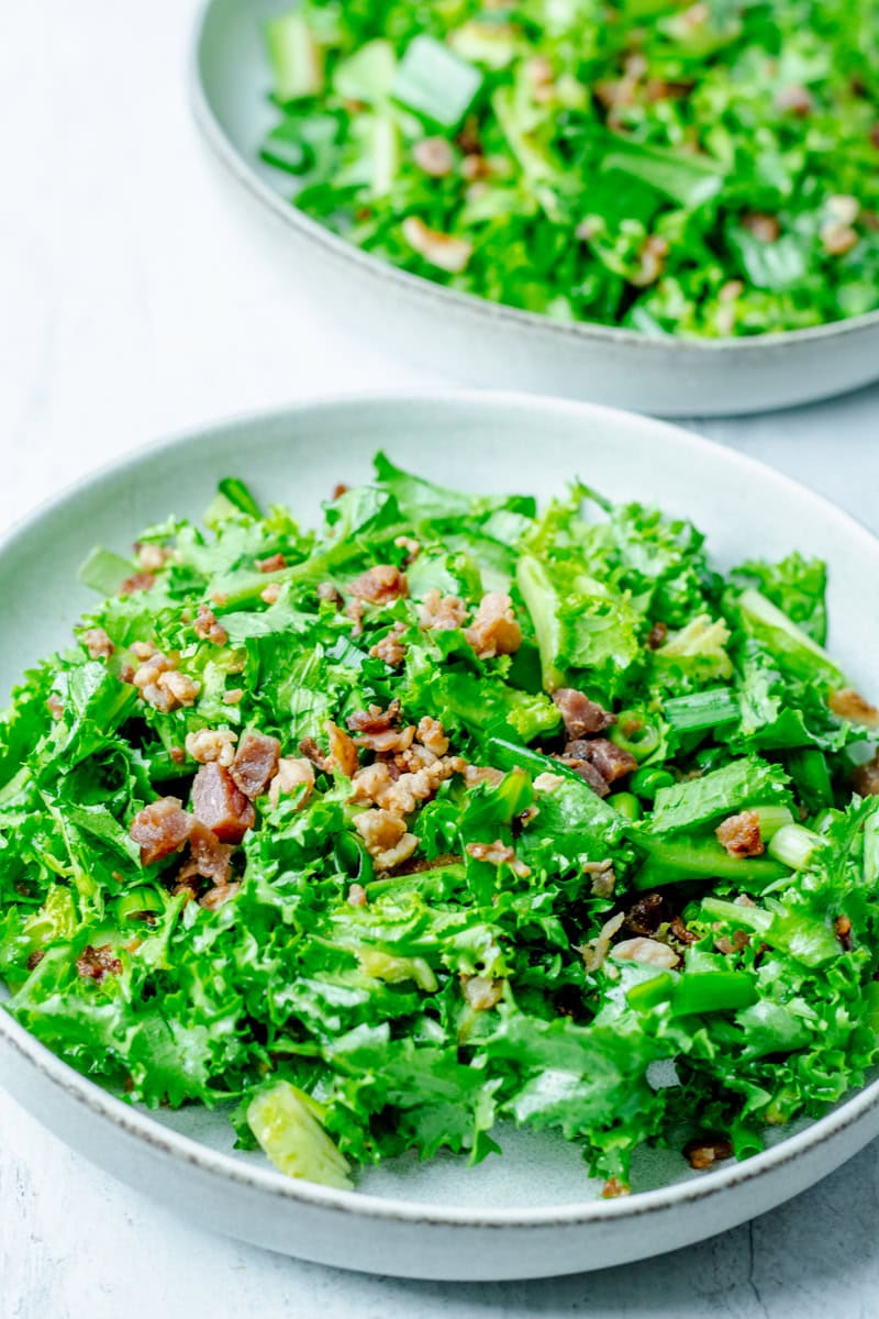 two bowls of endive salad with hot bacon dressing