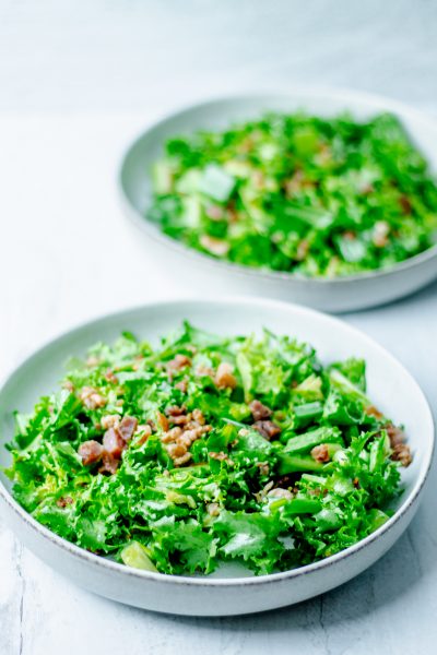 two bowls of hot bacon dressing endive salad