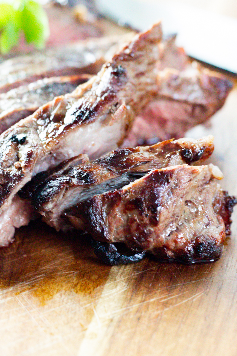 sliced marinated london broil on a wooden cutting board