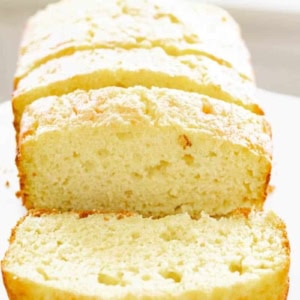 sliced 4-ingredient lemon zucchini bread on a white cake stand