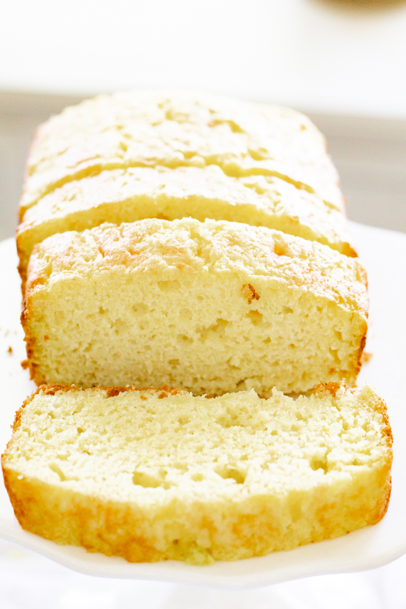 sliced 4-ingredient lemon zucchini bread on a white cake stand