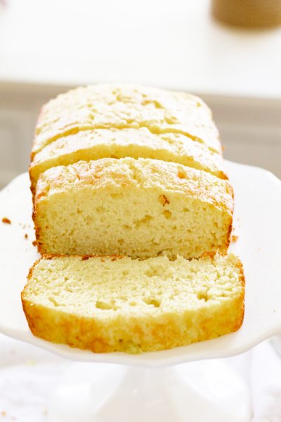 sliced 4-ingredient lemon zucchini bread on a white cake stand