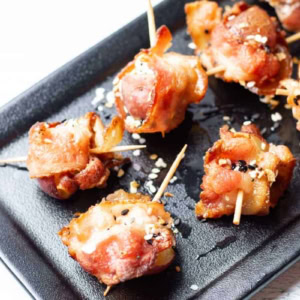 goat cheese, bacon, potato, and everything but the bagel seasoning appetizers on a black serving tray