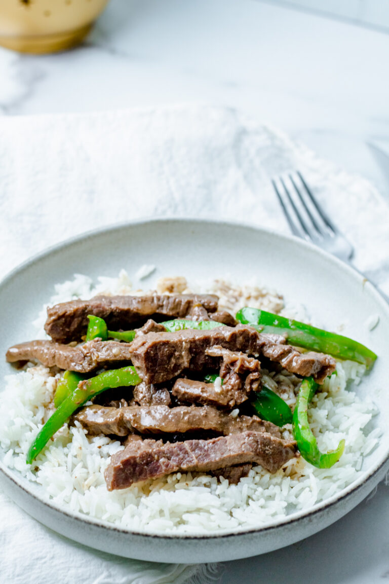 Instant pot beef pepper steak over rice in a bowl