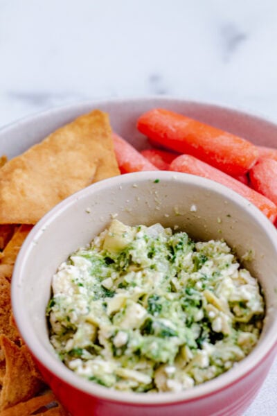 easy spinach, artichoke, and feta dip with pita chips and carrots