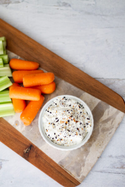 board with everything bagel dip and carrots and celery