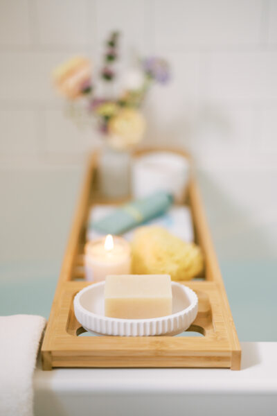 tray with a candle, soap, and various cozy home spa day essentials