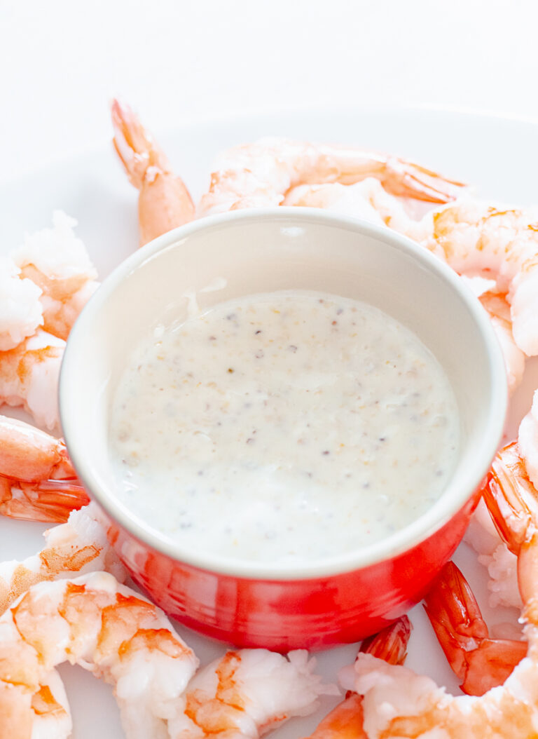 bowl of honey mustard horseradish dip surrounded by shrimp