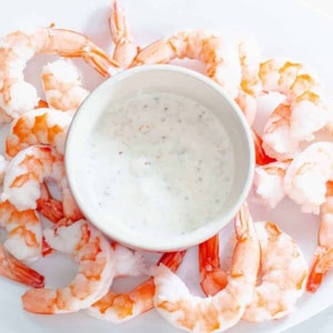 bowl of honey mustard horseradish dip surrounded by shrimp