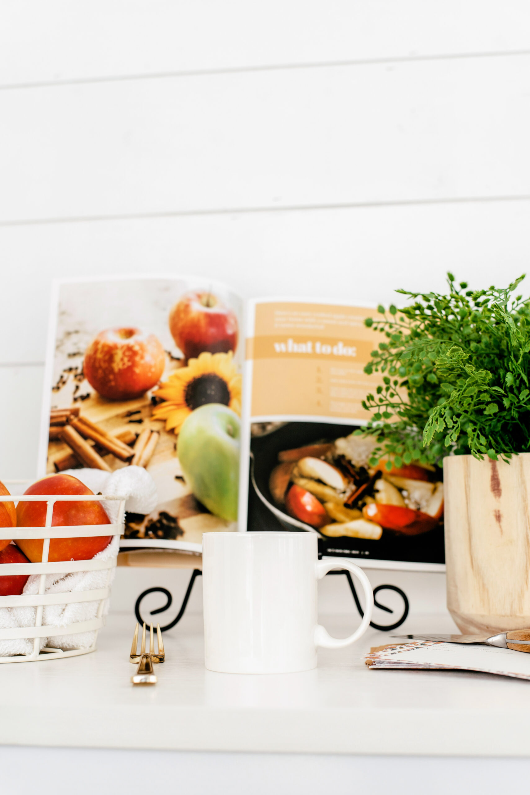 cookbook, mug, and plant in a cozy hygge kitchen