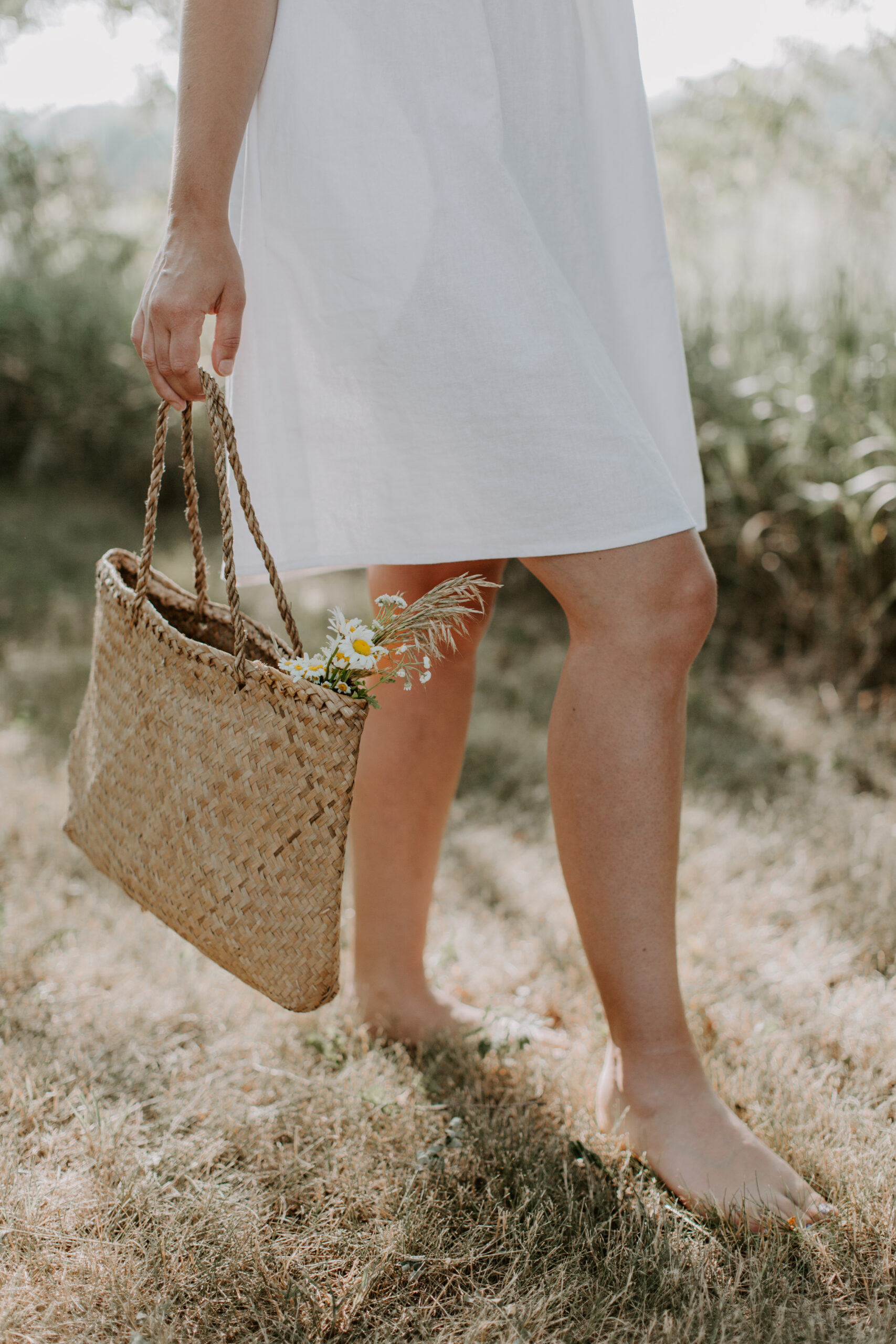 non descript woman walking in field