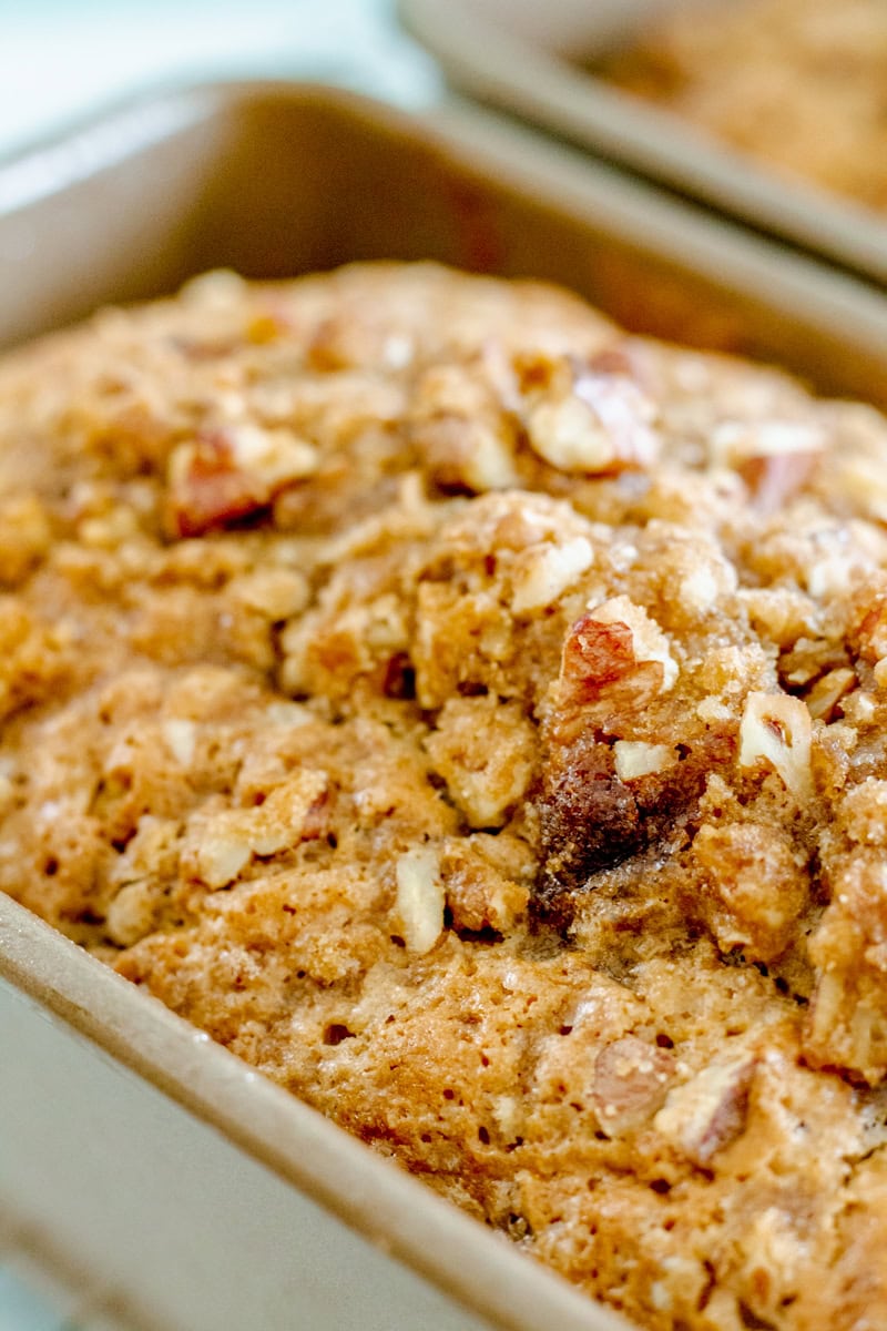 close up of pecan zucchini bread in a loaf pan