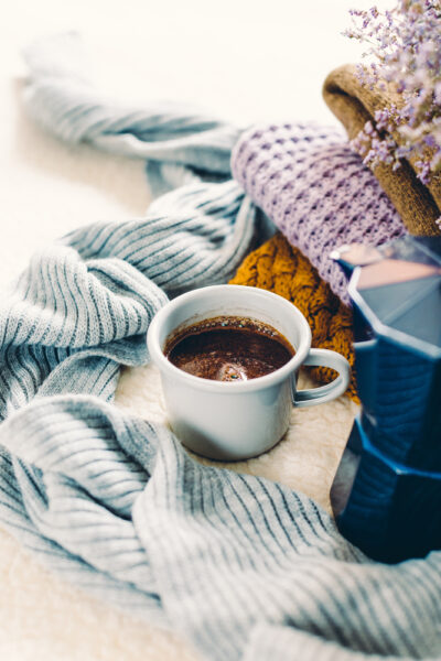 chunky knit blankets, french press, and a cup of coffee