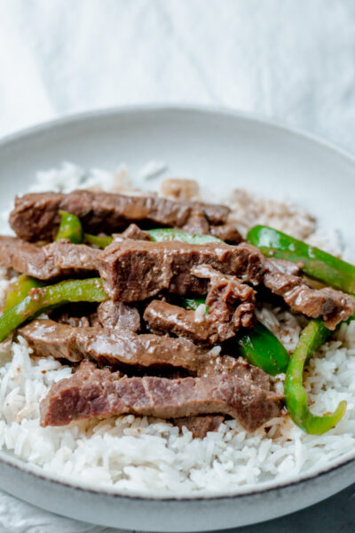 bowl of instant pot beef pepper steak and white rice