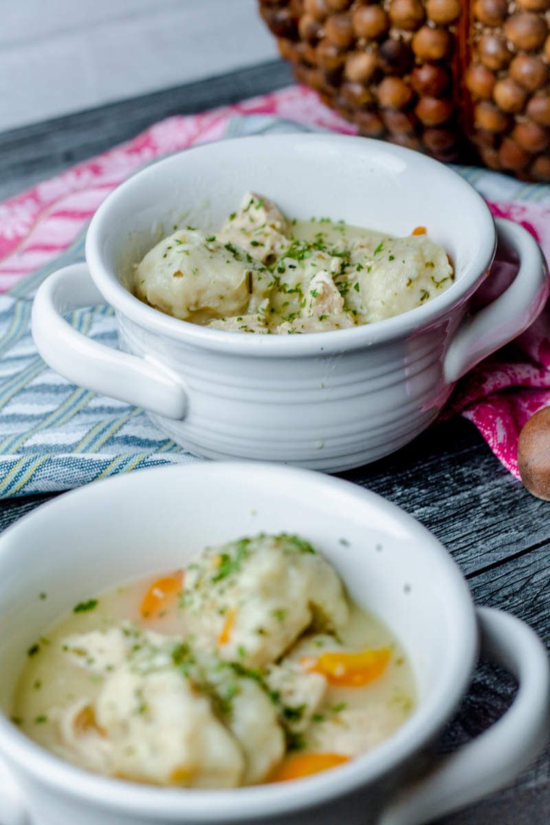white crock bowls filled with easy chicken and dumpling soup