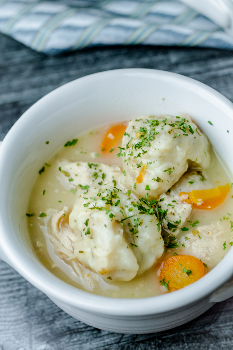 white crock bowl filled with easy chicken and dumpling soup