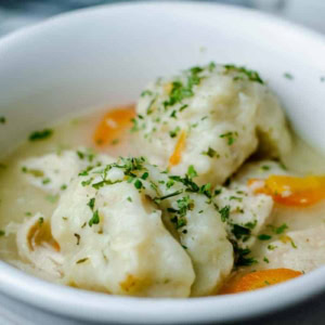 white crock bowl filled with easy chicken and dumpling soup