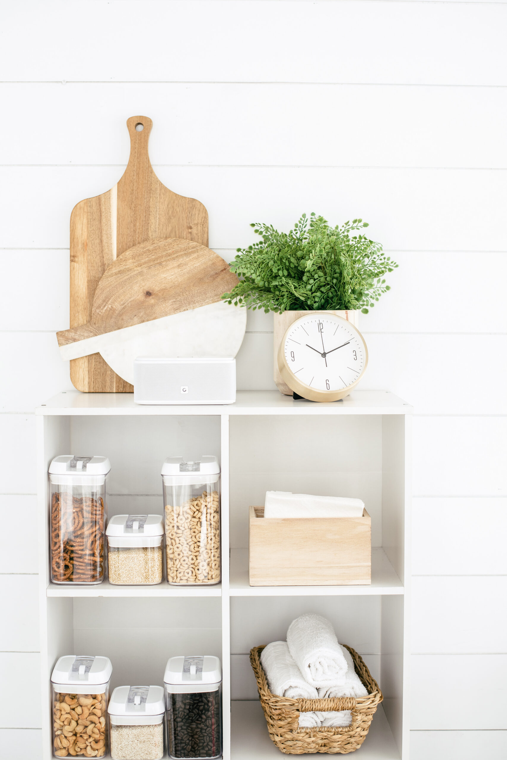 white cubed kitchen shelving filled with storage containers and decor