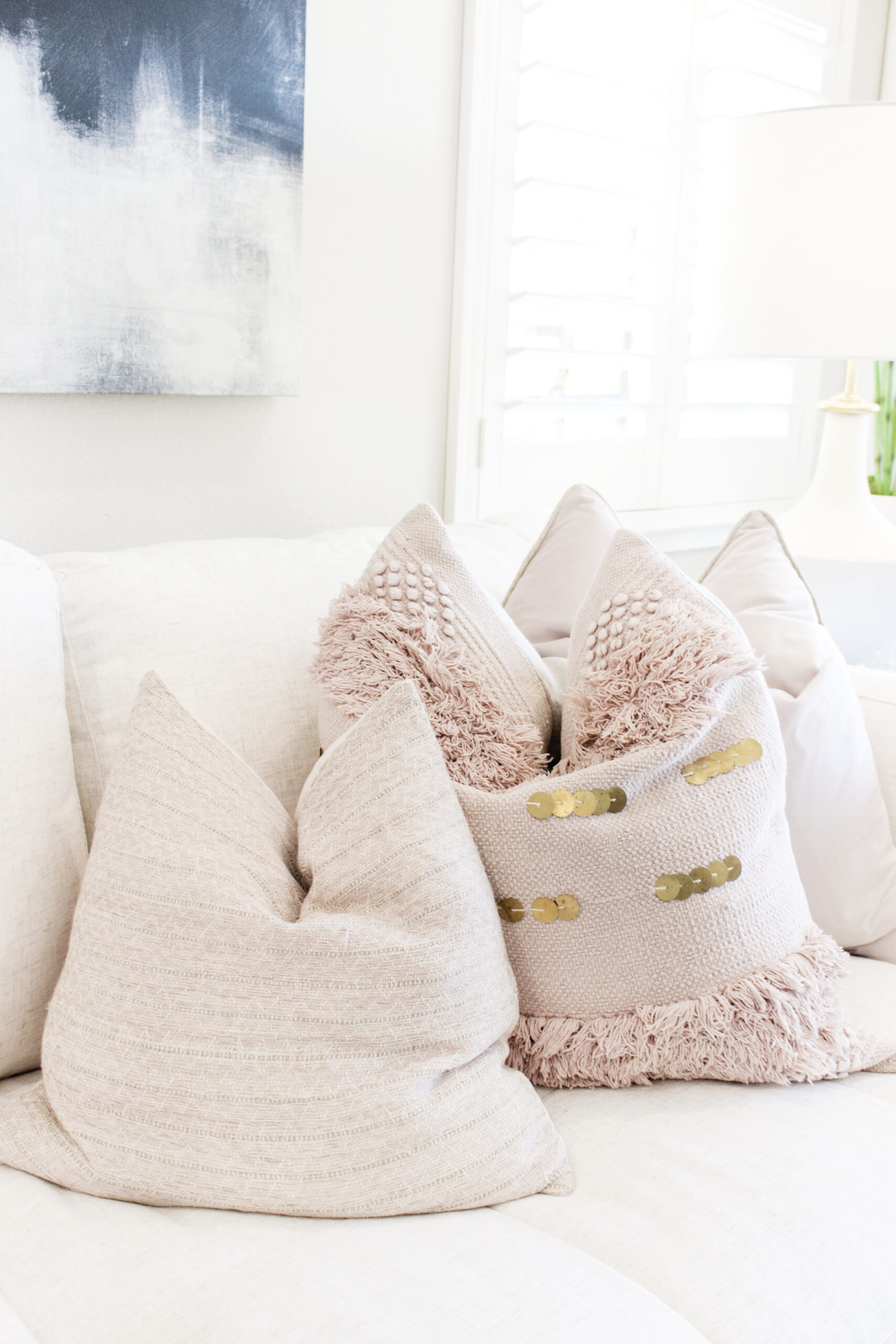 3 decorative show pillows on a couch in a living room